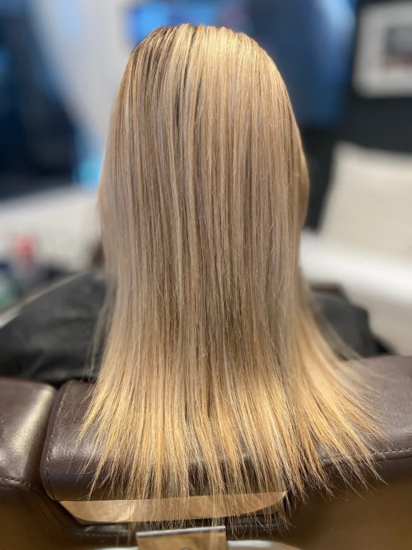 Smooth, straight blonde extensions seen from behind