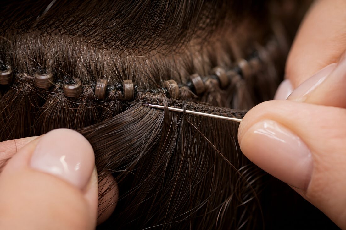 A hand-tied weft being sewn onto a beaded row
