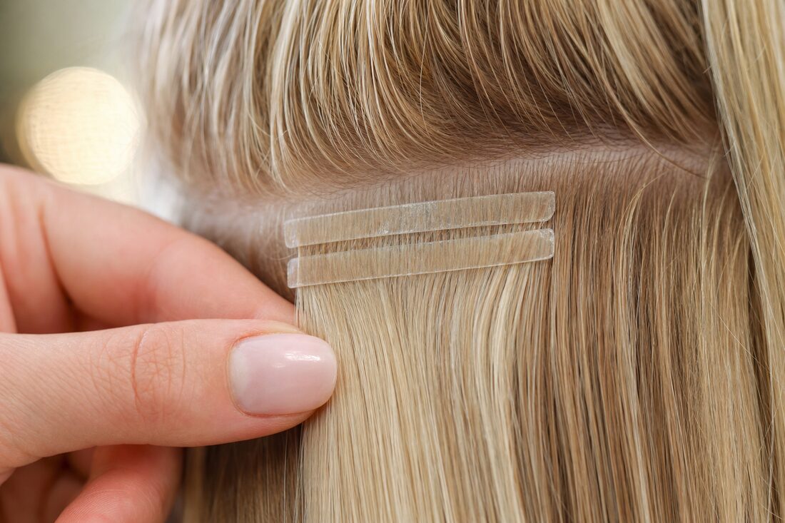 Tape-in wefts sandwiching a section of hair